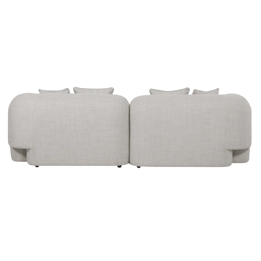 Back view of Almora sofa showing clean fabric finish and softly rounded rear silhouette