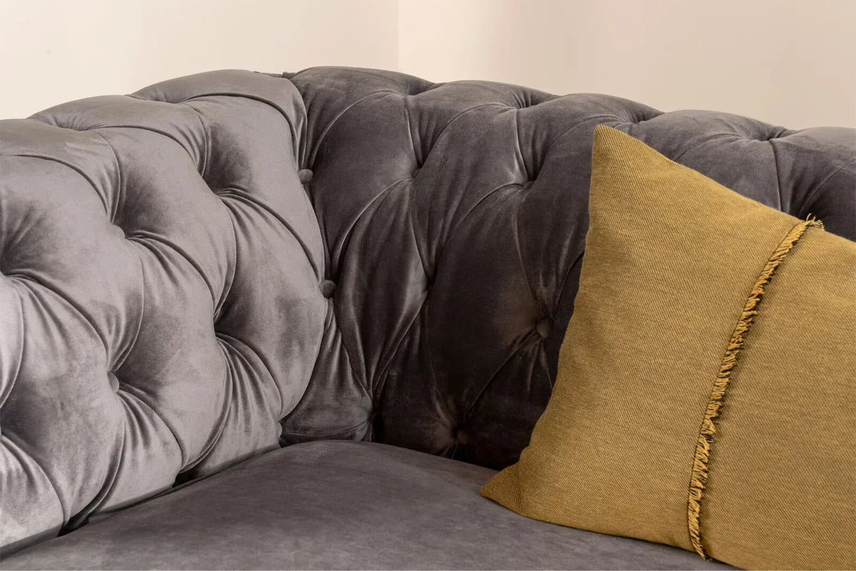 Close-up of the Cambridge's grey velvet tufted back and seat