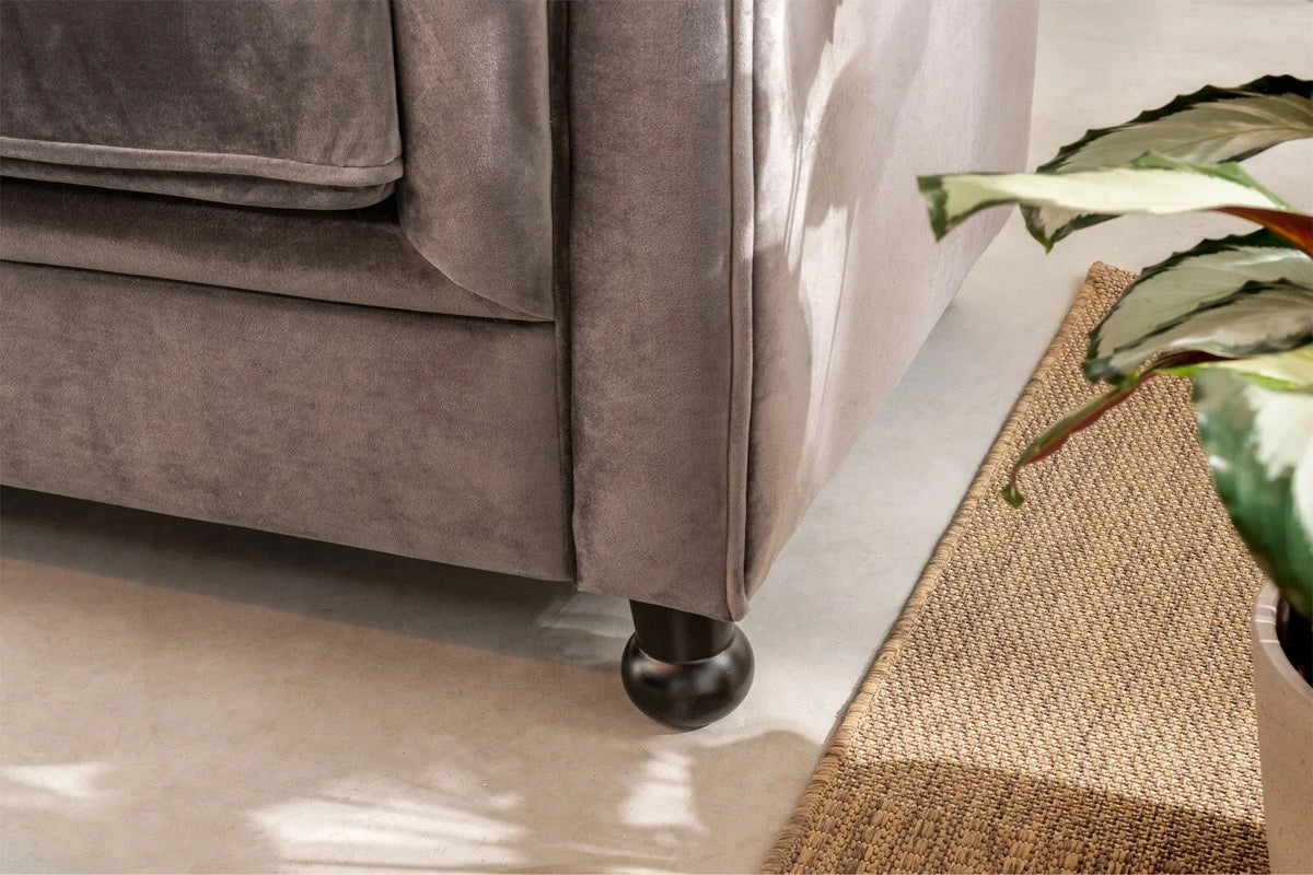 Close-up of the Cambridge's round foot in grey velvet